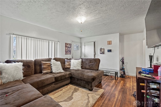 living room featuring dark hardwood / wood-style flooring, a textured ceiling, and baseboard heating