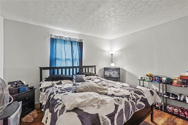 bedroom featuring hardwood / wood-style floors and a textured ceiling