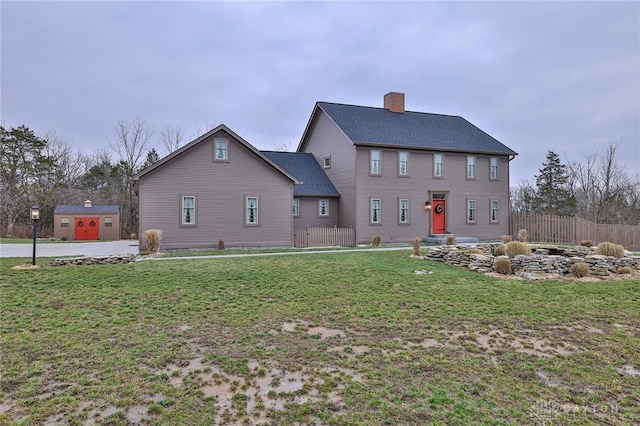 rear view of house with a lawn