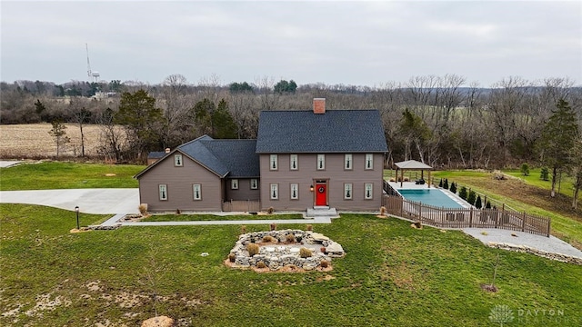 back of house featuring a yard and a gazebo