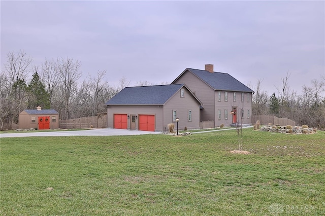 view of side of home featuring a lawn and a storage shed