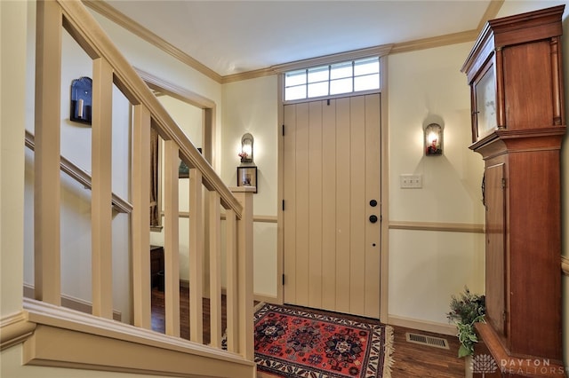 entrance foyer featuring crown molding and dark hardwood / wood-style floors