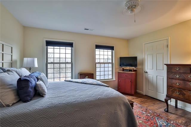 bedroom with ceiling fan and wood-type flooring