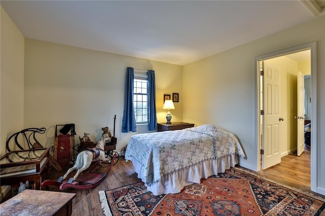 bedroom with hardwood / wood-style floors