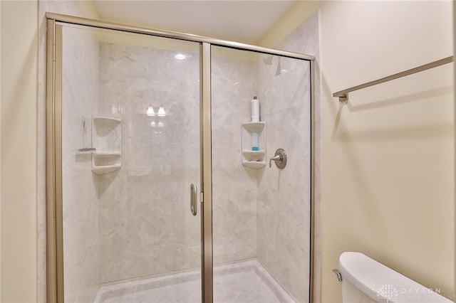 bathroom with toilet and walk in shower