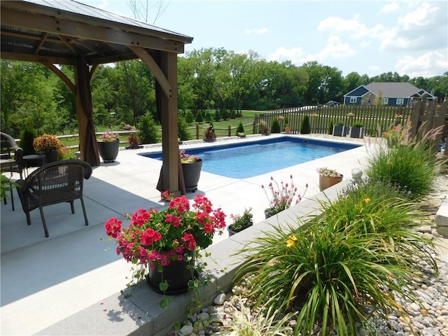 view of swimming pool with a gazebo and a patio area