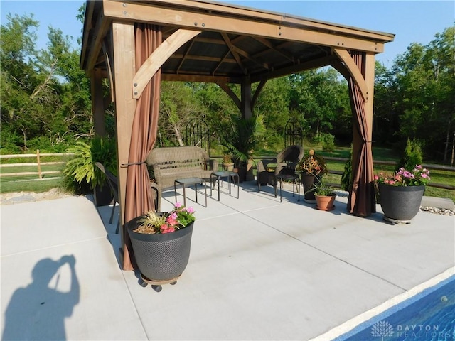 view of property's community featuring a gazebo, a patio area, and an outdoor hangout area