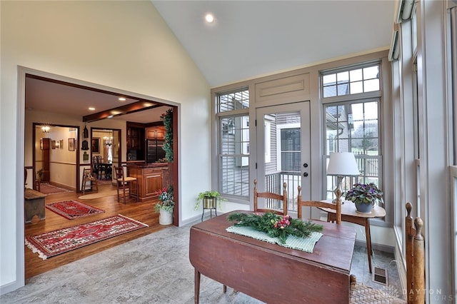 sunroom / solarium featuring lofted ceiling and a healthy amount of sunlight