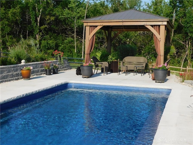 view of swimming pool with a gazebo and a patio area