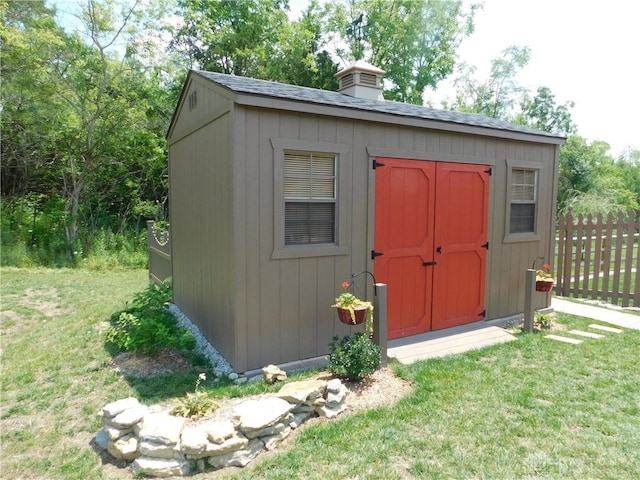 view of outbuilding featuring a lawn