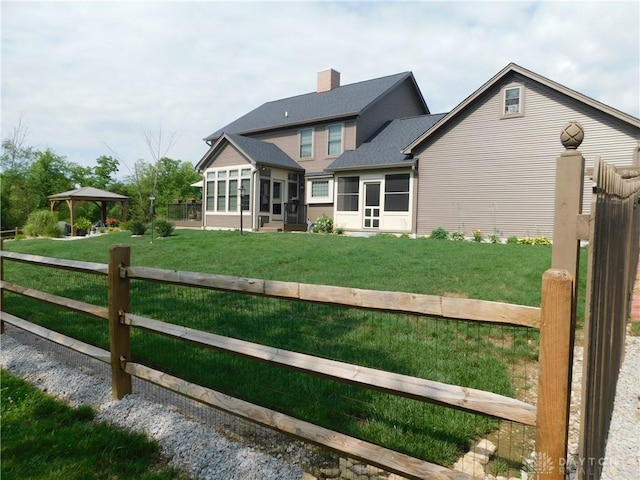 exterior space featuring a gazebo, a sunroom, and a yard