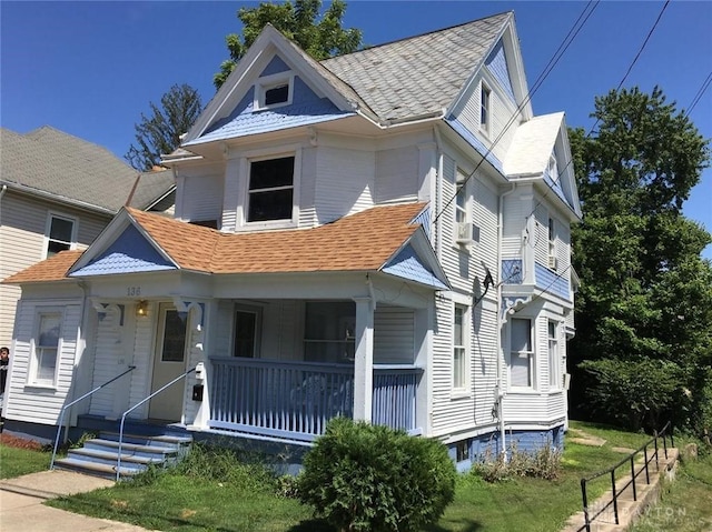 view of front facade with a front lawn and a porch