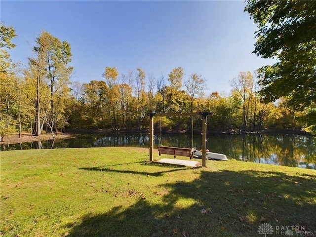 surrounding community with a yard and a water view