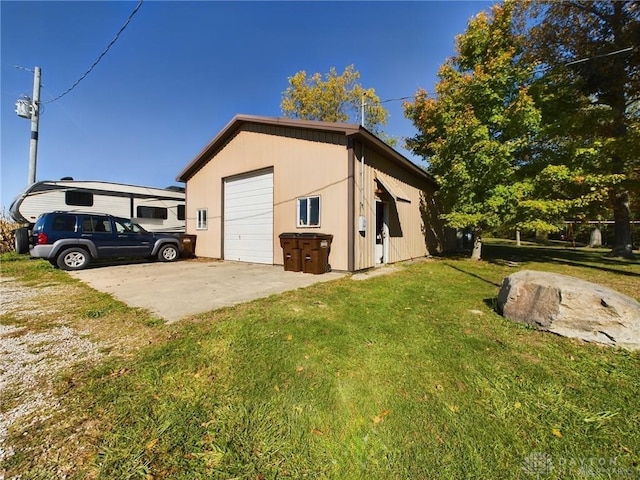 view of property exterior featuring a yard, an outdoor structure, and a garage