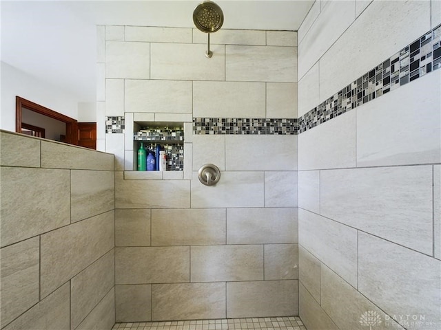 bathroom with a tile shower