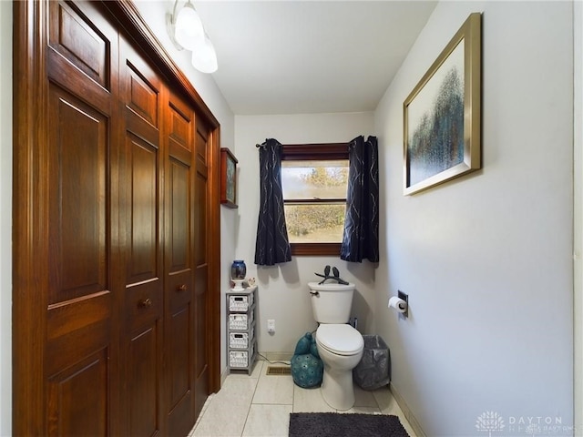 bathroom with tile patterned flooring and toilet