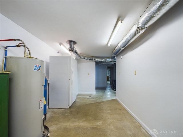 basement featuring white fridge and electric water heater