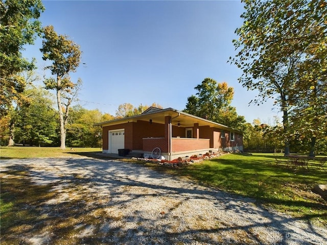 view of side of property with a garage and a lawn