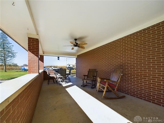 view of patio featuring a balcony and ceiling fan