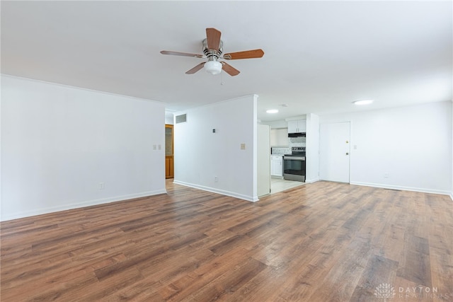 unfurnished living room with ceiling fan and wood-type flooring