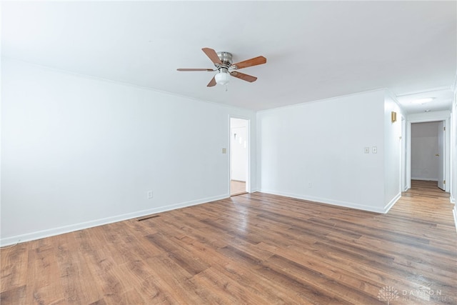 empty room featuring hardwood / wood-style floors and ceiling fan