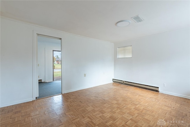 empty room featuring baseboard heating, light parquet flooring, a healthy amount of sunlight, and ornamental molding