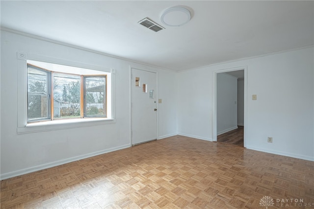 unfurnished room with parquet floors and crown molding