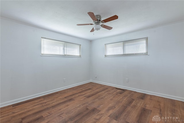 unfurnished room featuring ceiling fan, dark hardwood / wood-style flooring, and ornamental molding