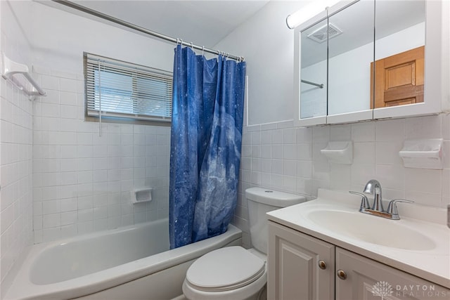 full bathroom with vanity, backsplash, toilet, shower / bath combo with shower curtain, and tile walls