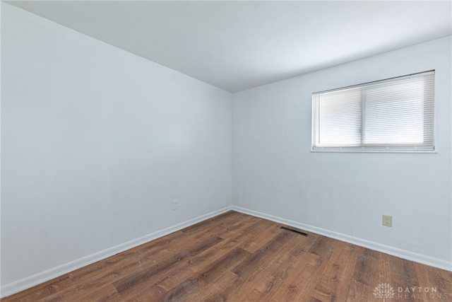 empty room featuring dark hardwood / wood-style flooring