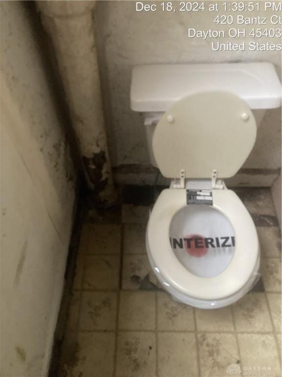 bathroom with toilet and tile patterned flooring