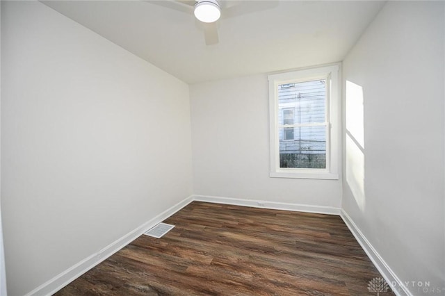 spare room with dark hardwood / wood-style floors and ceiling fan