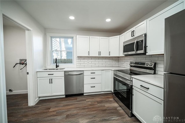 kitchen featuring dark hardwood / wood-style floors, white cabinetry, sink, and appliances with stainless steel finishes