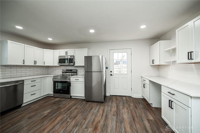 kitchen featuring tasteful backsplash, stainless steel appliances, white cabinetry, and dark hardwood / wood-style floors