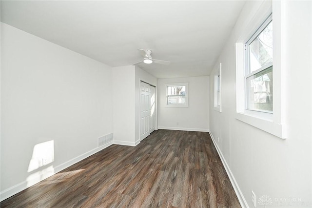 spare room with ceiling fan and dark hardwood / wood-style flooring