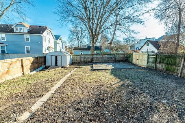 view of yard with a storage shed and a patio