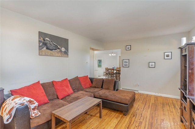 living room featuring a baseboard radiator and light wood-type flooring