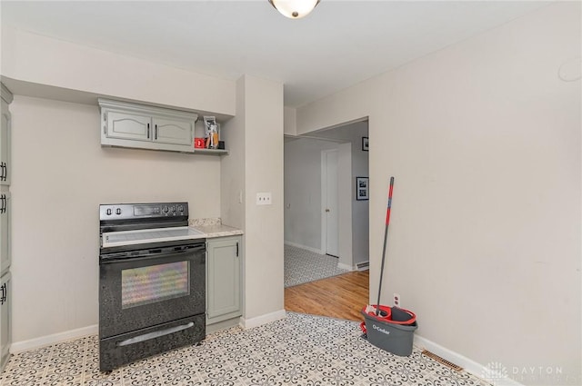 kitchen with black range with electric stovetop, light hardwood / wood-style flooring, and gray cabinets