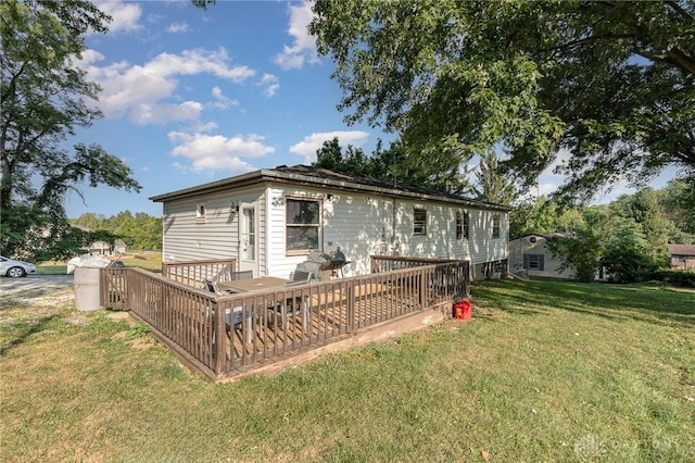 back of property with a lawn and a wooden deck