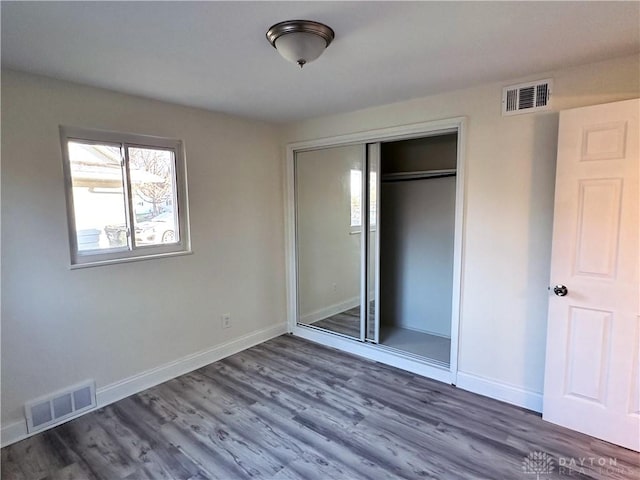 unfurnished bedroom featuring a closet and wood-type flooring