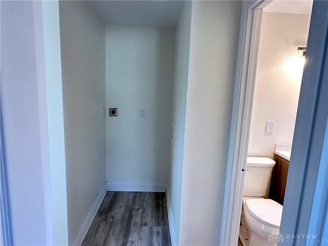 bathroom with hardwood / wood-style floors, vanity, and toilet