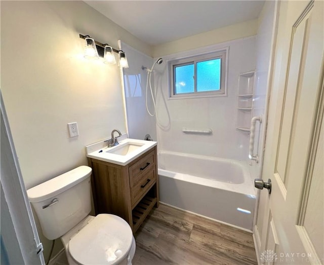 full bathroom with vanity, hardwood / wood-style flooring, toilet, and tub / shower combination