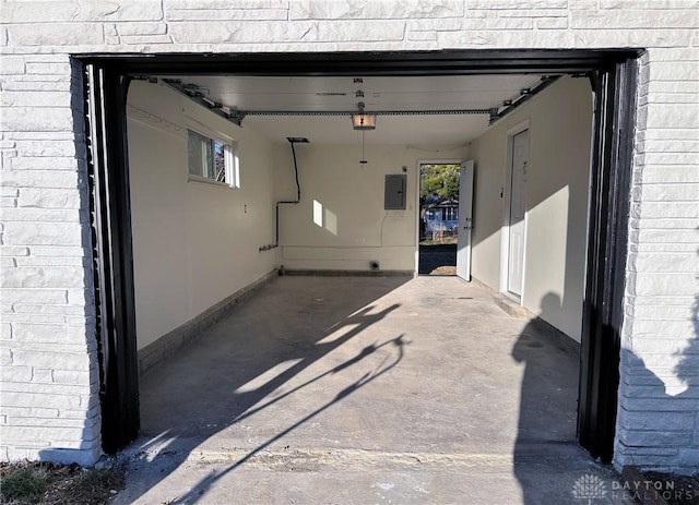 garage with electric panel and a garage door opener