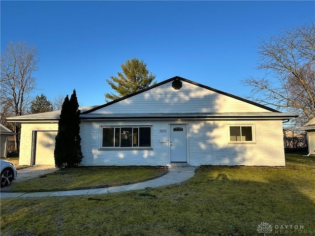 ranch-style house with a front lawn and a garage