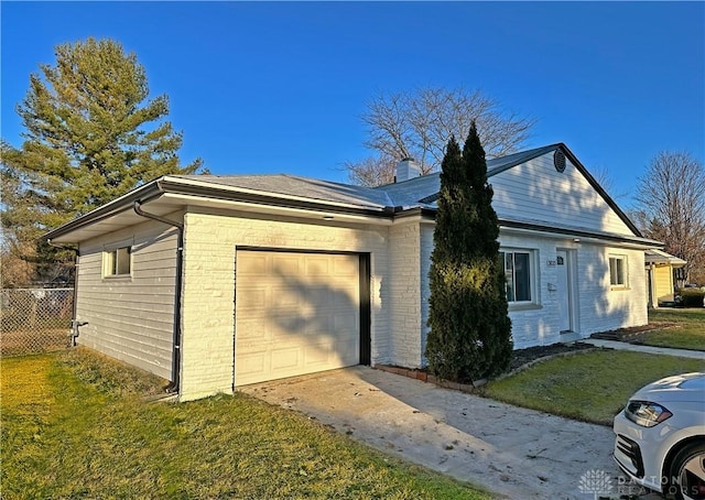 view of side of property with a yard and a garage