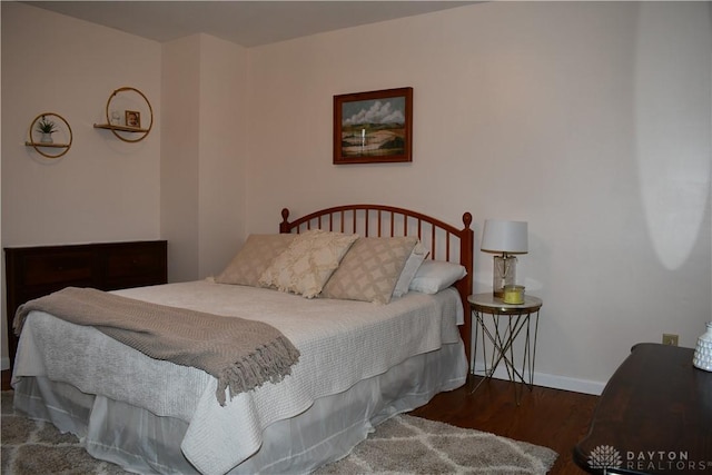 bedroom with dark hardwood / wood-style flooring