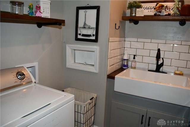 washroom featuring washer / dryer and sink