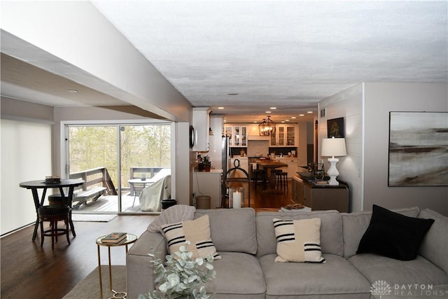 living room with wood-type flooring and a notable chandelier