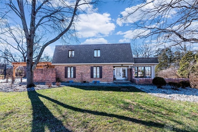 view of front of house featuring french doors, brick siding, a shingled roof, a front yard, and a pergola