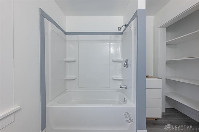 bathroom with hardwood / wood-style floors and tub / shower combination